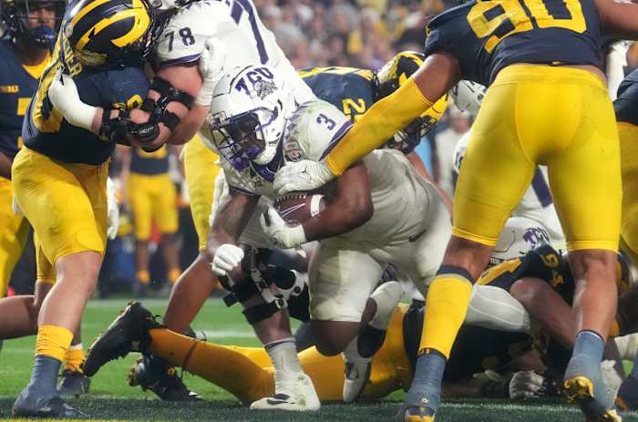 TCU running back Emari Demercado barrels into the end zone against Michigan